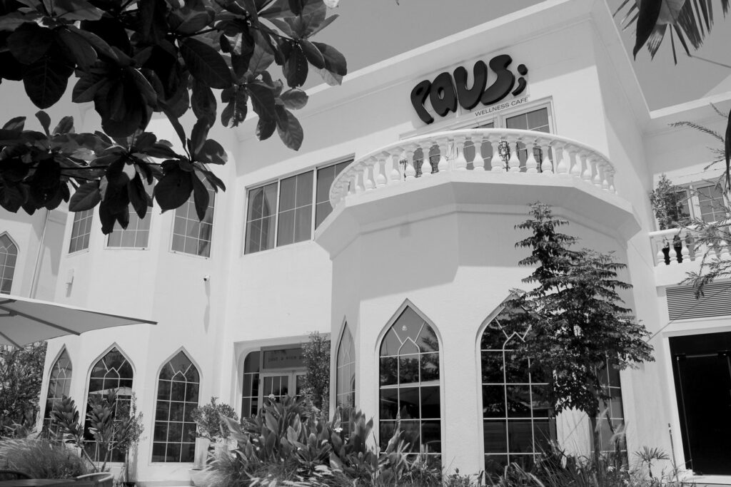 A view of PAUS Dubai from the outside. Large letters dreamily spell PAUS on the external facade of the structure.